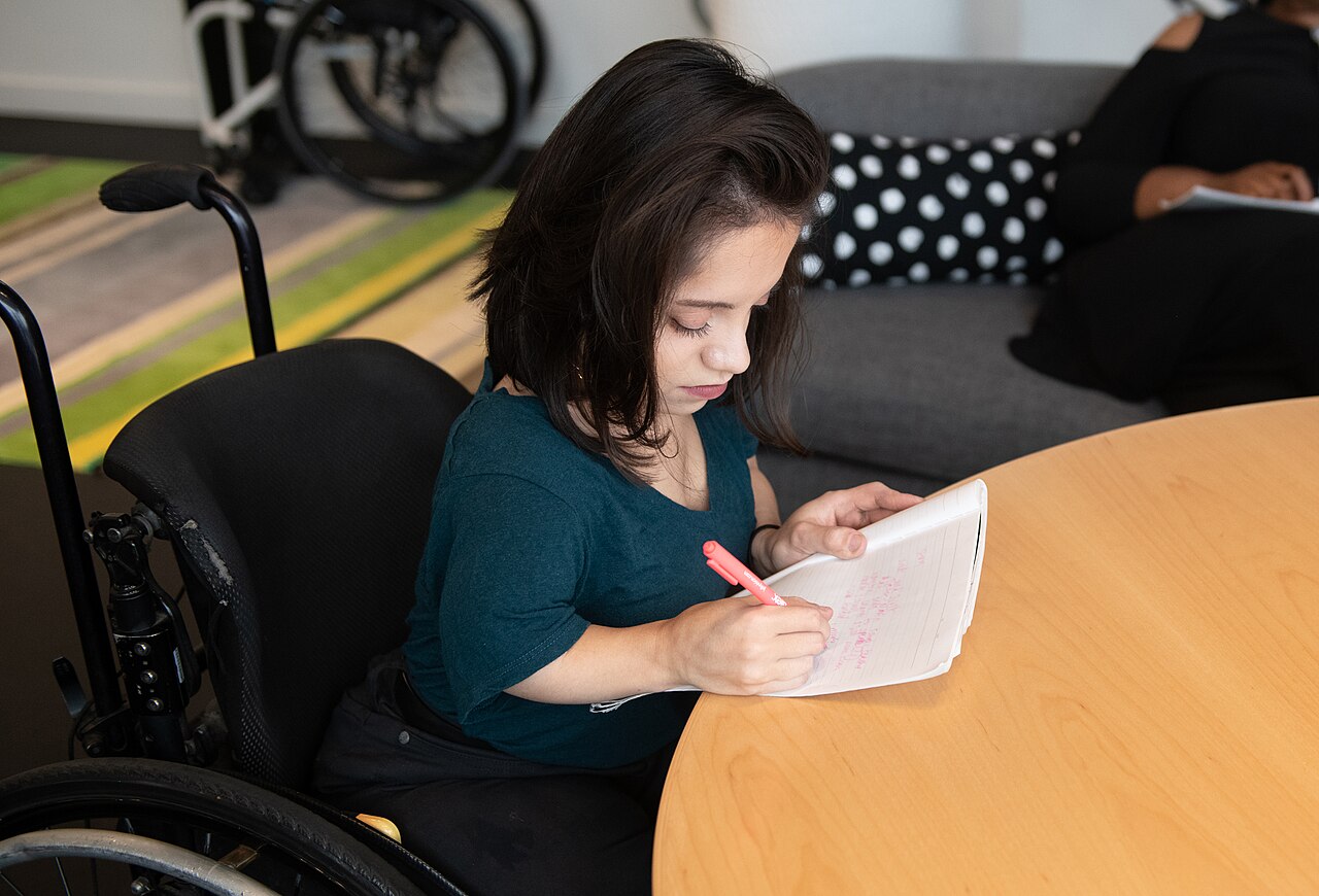 A person writing notes at a table