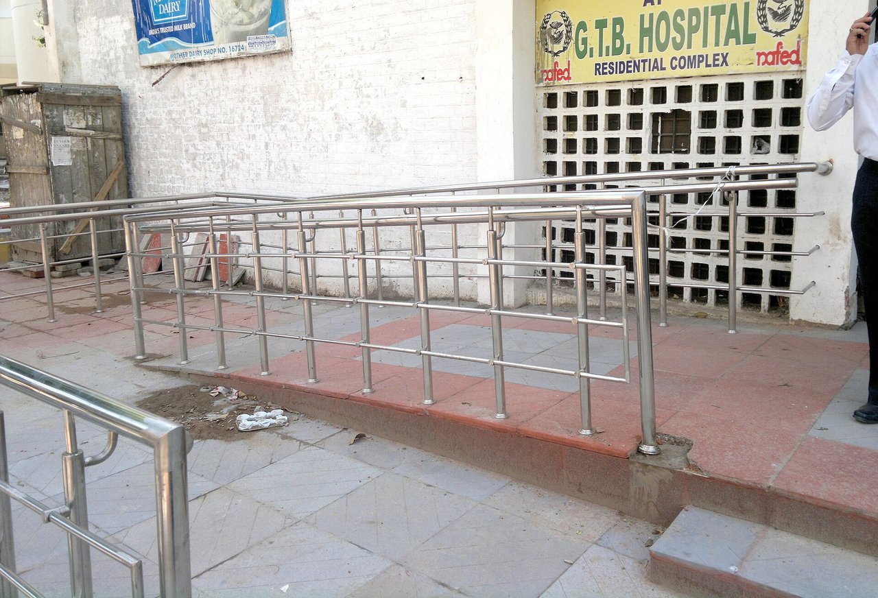 An accessible building entrance with a ramp and handrails