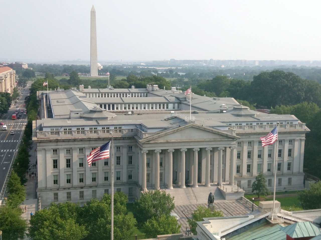 The U.S. Treasury Building in Washington, D.C., with the Washington Monument behind it