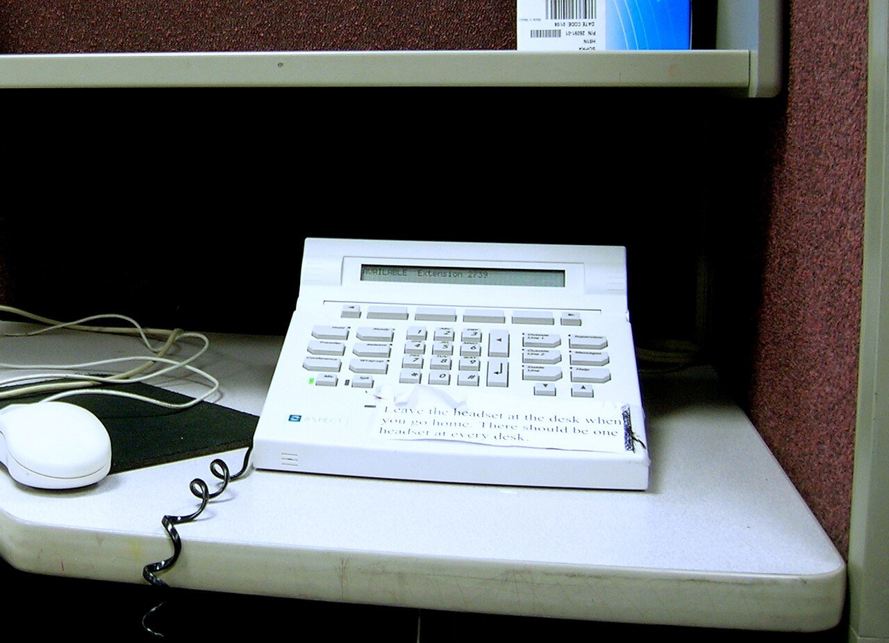 A desk telephone with a row of call-handling buttons in a call center
