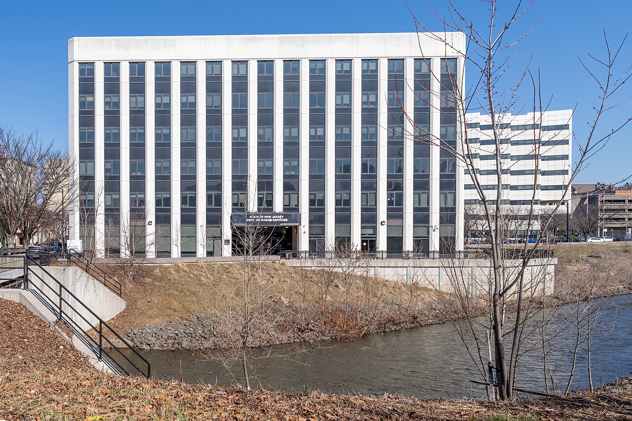 The New Jersey Department of Human Services building in Trenton beside the Assunpink Creek
