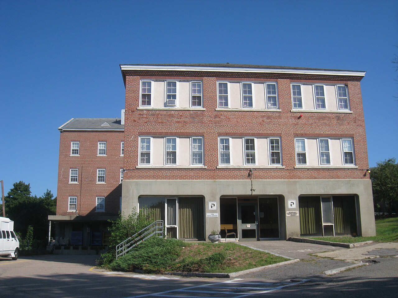 A three-story brick building at the former Walter E. Fernald State School in Waltham, Massachusetts