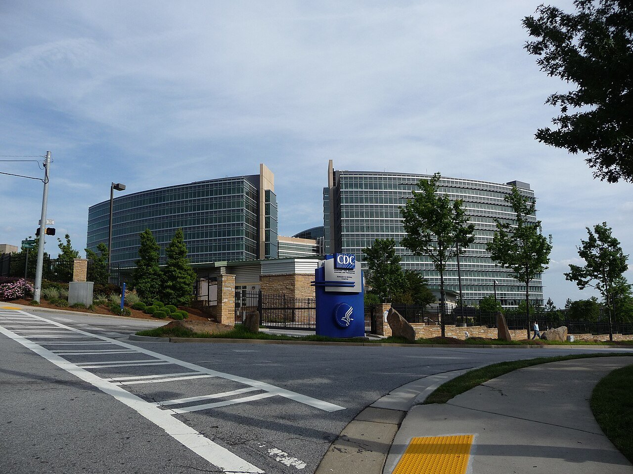 The glass towers and blue entrance sign of the Centers for Disease Control and Prevention headquarters in Atlanta