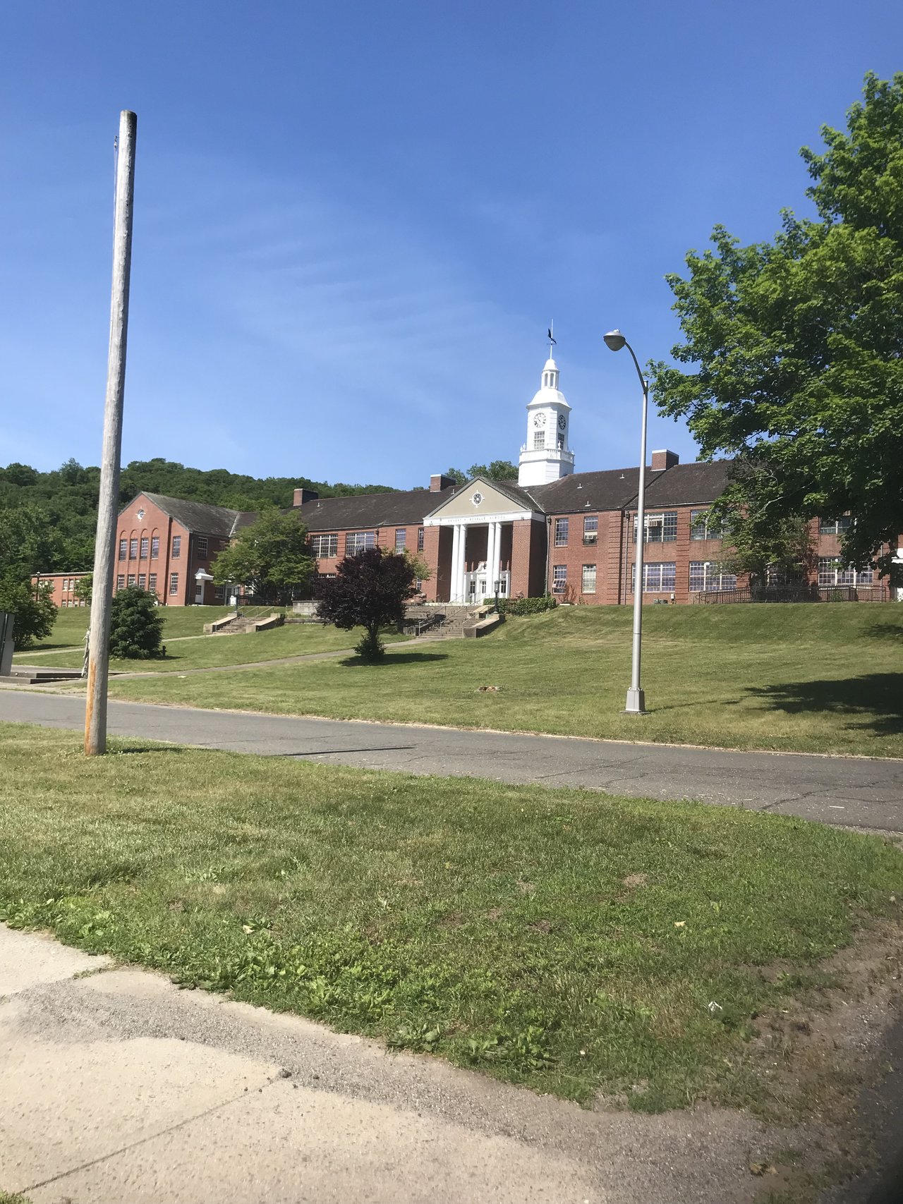 The brick Roselle School Building with a white clock tower on the Southbury Training School campus