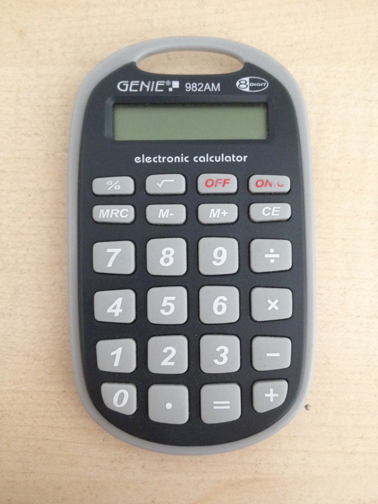 Close-up of the keypad of a black pocket calculator with gray buttons