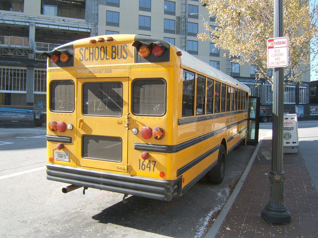 The back of a yellow school bus parked on a city street in Atlanta